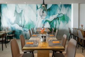 a dining room with a long table and chairs at Wyndham Garden Munich Messe in Munich
