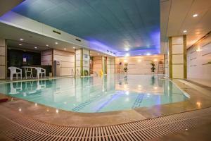a large swimming pool in a large building at Grand Soluxe Zhongyou Hotel in Shanghai