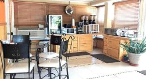 a kitchen with a table and chairs in it at Americas Best Value Inn & Suites Macon at Sunset Dr in Macon