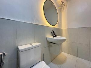 a bathroom with a sink and a toilet and a mirror at Fafje Luxury in Mama +3 photos