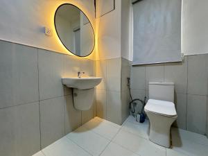 a bathroom with a sink and a toilet and a mirror at Fafje Luxury in Mama