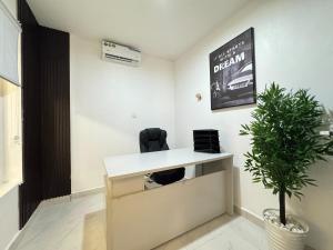 an office with a desk and a potted plant at Fafje Luxury in Mama