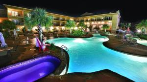 a resort with a large swimming pool at night at Holiday Inn Express & Suites Fredericksburg By IHG in Fredericksburg +39 photos