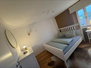 a small bedroom with a bed and a mirror at Schlossblick in Sulzbach-Rosenberg