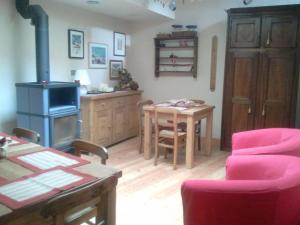 a living room with a stove and a table at La Niche B&B in La Thuile