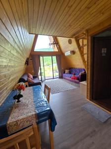 a room with a table and a couch in a house at Canyon garden martvili in Martvili