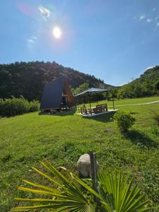 a park with a bench and a gazebo at Canyon garden martvili in Martvili