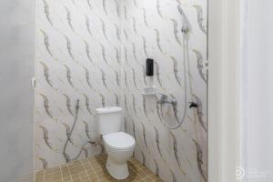 a bathroom with a toilet and a shower at SG Hotel Pangandaran in Pangandaran +33 photos