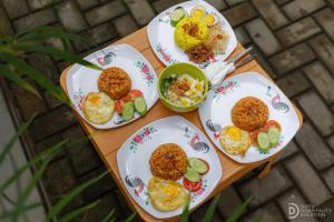 a table with four plates of food on it at SG Hotel Pangandaran in Pangandaran