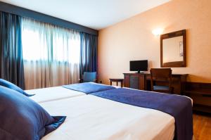 Łóżko lub łóżka w pokoju w obiekcie Hotel Las Provincias