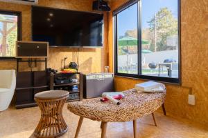 a room with a table and a tv and a table and chairs at Dream Dome Glamping Studio Ichihara in Ichihara