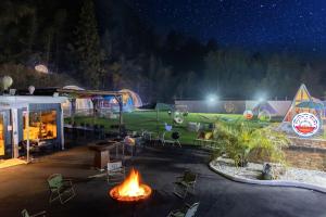 a group of chairs and a fire pit at night at Dream Dome Glamping Studio Ichihara in Ichihara