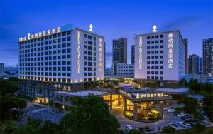 two tall buildings in a city at night at Venus Royal Hotel （Kirin Parkview Hotel） in Shatsing