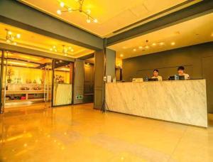 two people sitting at a counter in a restaurant at Jinjiang Inn Style Shenyang The Palace Huaiyuan Gate in Shenyang