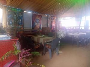 a restaurant with a table and chairs and a dining room at Gods gift guesthouse in Arambol