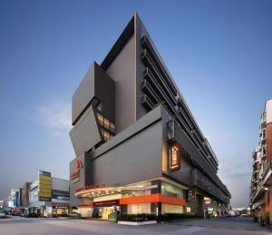 a building with a sign on the side of it at Aishang Hotel (Lecong Furniture Mall, Foshan) in Shunde