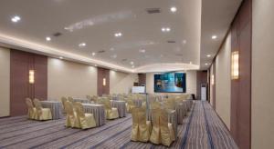 a banquet hall with tables and chairs in a room at T Social Hotel Guangzhou Railway Station Branch in Guangzhou