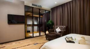 a hotel room with a bed and a chair at Lotus Blu Hotel in Buenavista