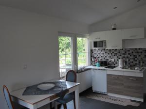 a kitchen with white cabinets and a table and a table and chairs at Haus Kummer in Selm