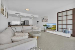 a living room with a couch and a table at Reflection on the Sea in Gold Coast