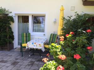 a patio with a table and chairs and a window at Appartement Horngacher in Scheffau am Wilden Kaiser