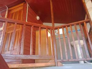 an inside view of a room with wooden walls at Green moon Home stay room2 in Buriram