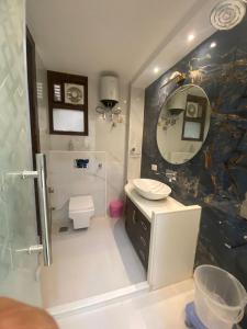 a bathroom with a sink and a toilet and a mirror at Hotel Liyan Inn in Kānpur +38 photos