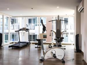 a gym with several exercise equipment in a room at The Violin - Sriracha in Ban Thung Sukla