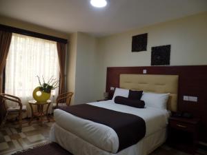 a bedroom with a large bed in a room at Villa Leone Boutique Hotel in Nairobi