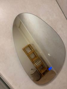 a mirror on a wall with a room in it at B&B s12 in Doetinchem