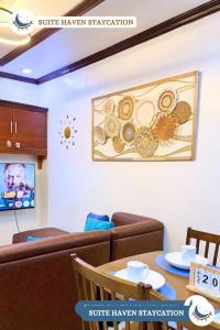 a living room with a couch and a table at Suite Haven Staycation in Sampong