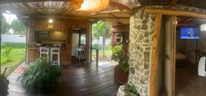 an outside view of a small house with a stone wall at Fare Hinavainui in Orufara