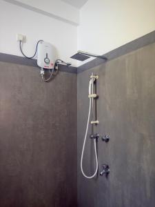 a shower in a bathroom with a camera on the wall at Viska Villa 2 Bedroom Home 5 min to Hiriketiya in Nilwella