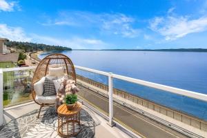 a dog sitting in a chair on a balcony overlooking the water at Water View Retreat Near Beach Park & City in Redondo