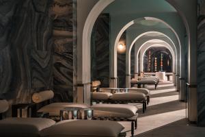 a row of massage beds in a room with arches at Hotel Indigo Wuxi Qingming Bridge in Wuxi
