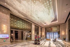 a large lobby with a large chandelier in a building at The Qube Hotel Nanchang East in Nanchang +286 photos