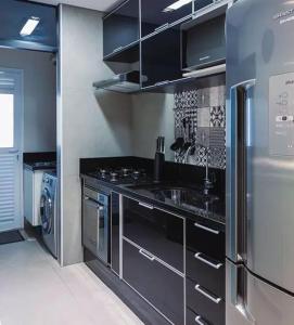 a kitchen with a stove and a sink and a refrigerator at Proventures in Walvis Bay