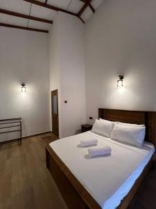 a bedroom with a bed with two pillows on it at Cashew Garden Resort & Restaurant in Dambulla