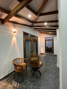 a living room with two chairs and a table at Cashew Garden Resort & Restaurant in Dambulla