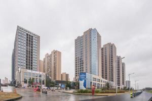 a group of tall buildings in a city at GRACE Select Hotel (Kunshan Huaqiao International Convention Center) in Xinqiao