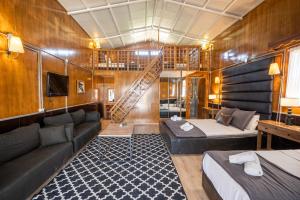 a room with a bed and a couch in a boat at simlarda aquapark otel in Ayvalık