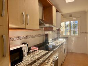 a kitchen with a sink and a counter top at Apartamento Adelfa By Solymar Holiday in Benajarafe