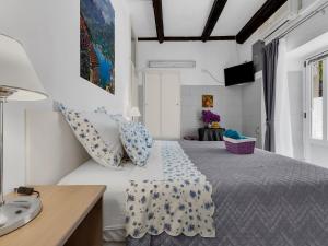 a bedroom with a bed with blue and white pillows at Apartments Kata - Studio Apartment in Makarska