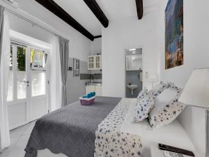 a white bedroom with a bed and a bathroom at Apartments Kata - Studio Apartment in Makarska