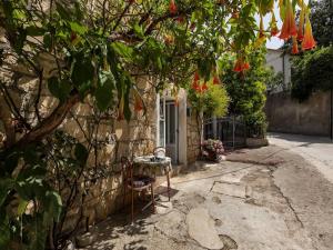 a table and a chair in front of a house at Apartments Kata - Studio Apartment in Makarska