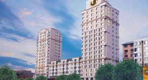 two tall buildings with a clock on top of them at Anshan Camilla Business Hotel in Anshan