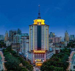 a tall building with a yellow dome on top of it at Vienna Hotel Tianjin Guizhou Road Branch in Tianjin