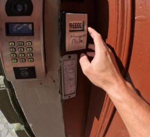 a hand is pressing a pay meter on a door at Margarets Place in Braşov