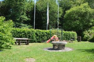 a park with a playground in the grass at Haus Waldfrieden OG in Thalfang +11 photos