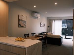 a kitchen and living room with a couch and a table at The Petone Beauty - Flash, Beachside in Lower Hutt